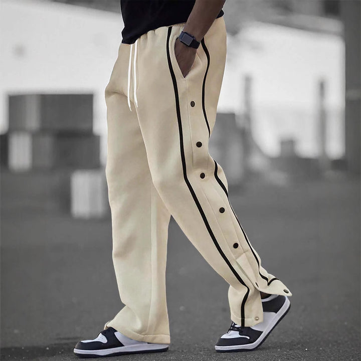 Men's casual training pants with side snap button placket, elastic waistband and contrasting piping Mune Fashion