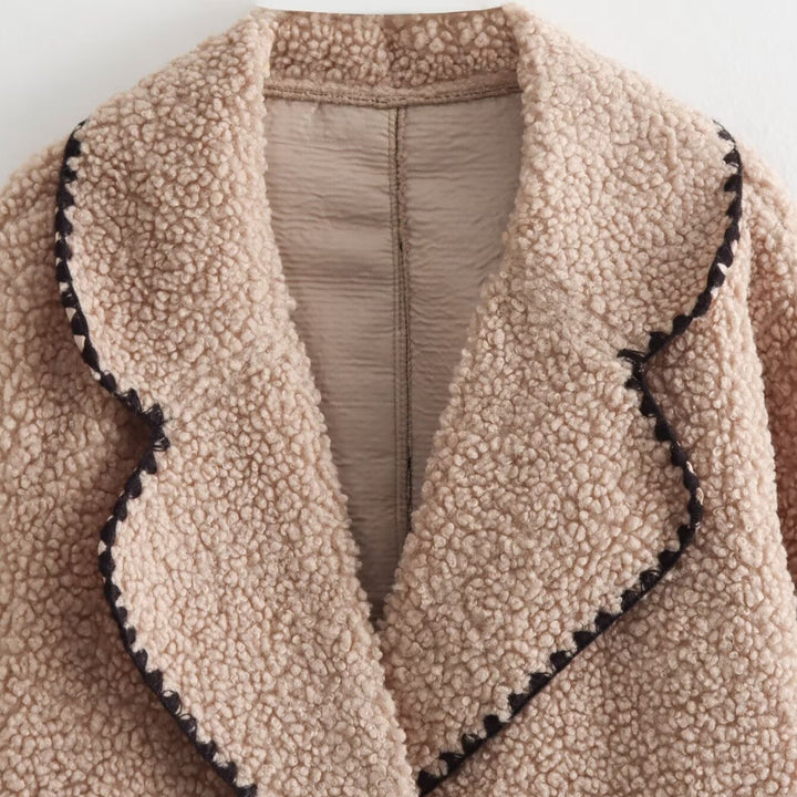 Women’s short cut teddy coat with large shawl collar, patch pockets, and contrasting decorative trim Mune Fashion