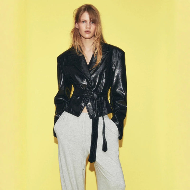 Women’s short blazer in patent leather look with waist belt and flowing lapel Mune Fashion