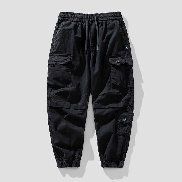 Herren Leichte Canvas-Cargohose im Joggerstil mit elastischem Bund, segmentierten Kniepaneelen und verdeckten Klappentaschen Mune Fashion