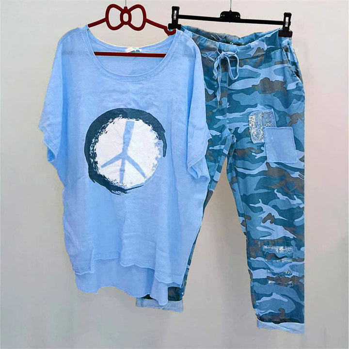 Women’s casual leisure two-piece with wide-cut linen look shirt, peace symbol and camouflage jog pants with patch details Mune Fashion