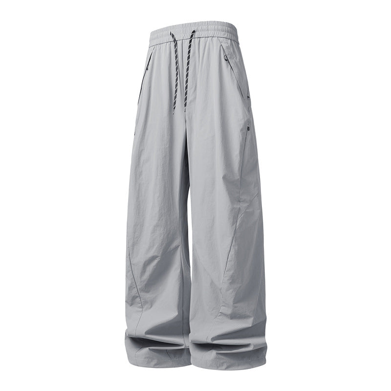 Unisex Wide Tech Baggy Pants with elastic drawstring, zip pockets & water-repellent nylon look Mune Fashion