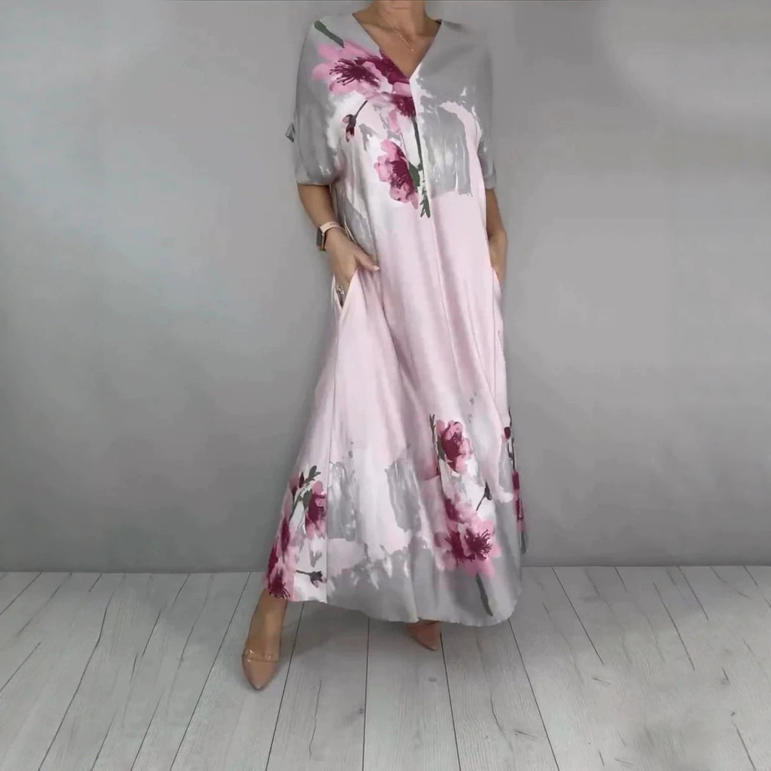 Women's maxi dress with a flowing fall, V-neck, side pockets, and floral watercolor look Mune Fashion