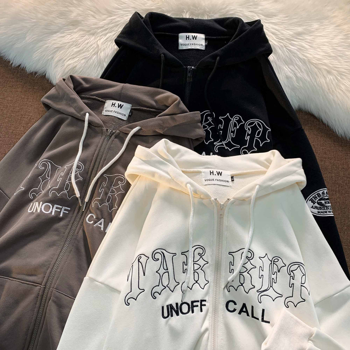Unisex zip-up hoodie with Gothic lettering, hood, kangaroo pocket, and sleeve flock patch Mune Fashion