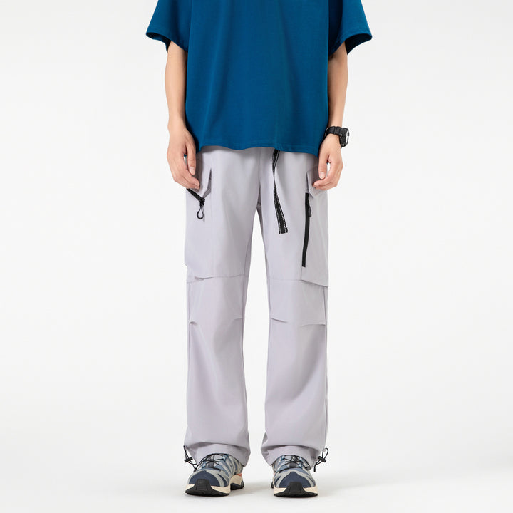 Unisex Wide technical cargo pants with multi-function pockets, drawstring and adjustable leg hems Drune