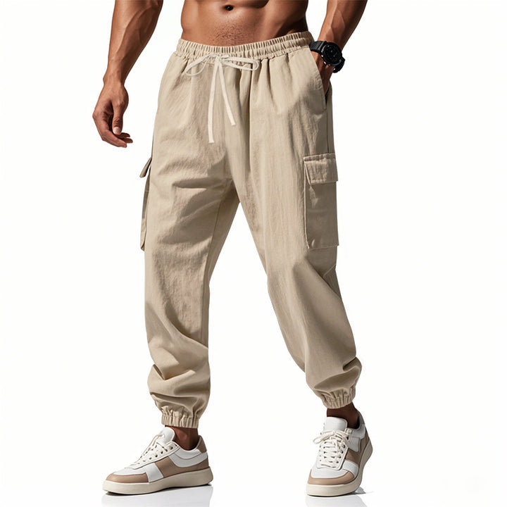 Men's tapered joggers in utilitarian style with elastic waistband, drawstring, and flap pockets Mune Fashion
