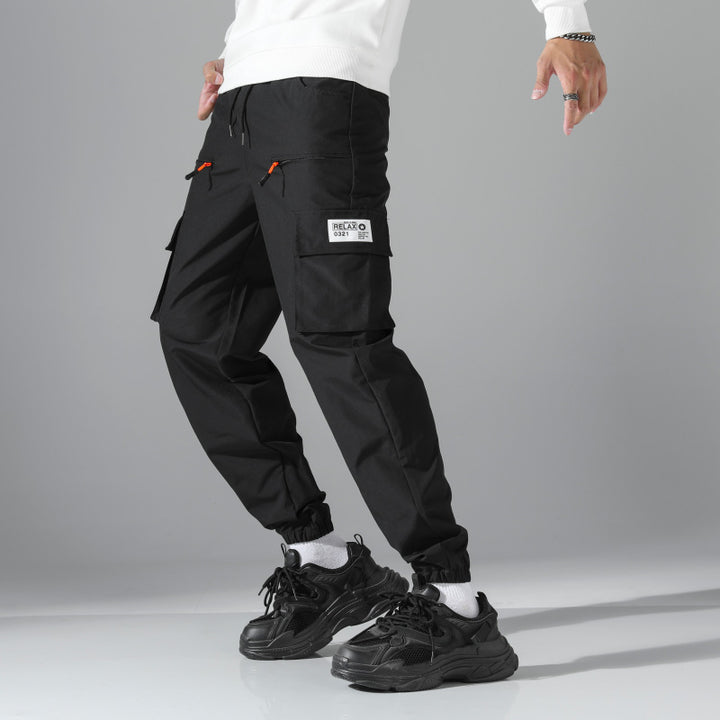 Men's tapered cut utility cargo pants in jogger style with drawstring waistband, zippered pockets & elastic leg cuffs Mune Fashion
