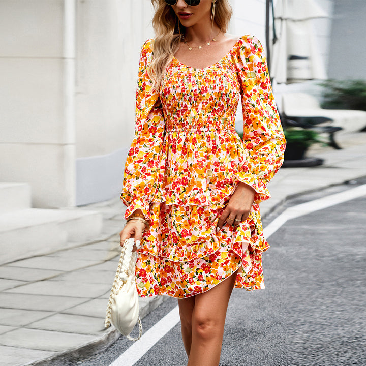 Women’s smocked Carmen mini dress with puff sleeves, tailored smocked bodice, and asymmetric ruffle hem Mune Fashion