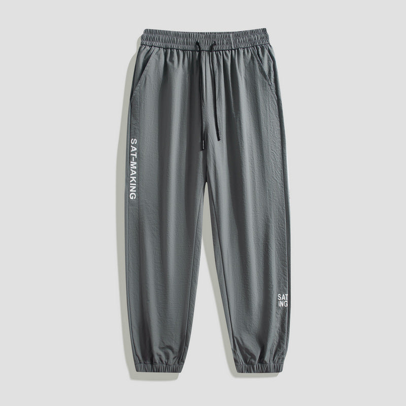 Men's sporty jogging pants with elastic waistband and zippered pockets Mune Fashion