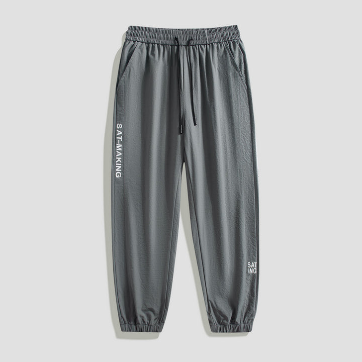 Men's sporty jogging pants with elastic waistband and zippered pockets Mune Fashion