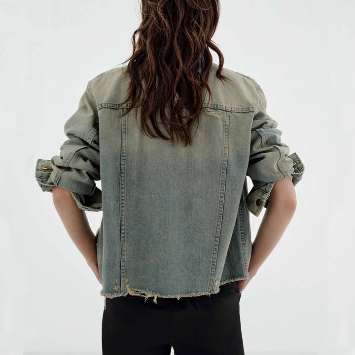 Women’s oversized destroyed denim jacket with raw hem, patch chest pockets, and vintage wash Mune Fashion