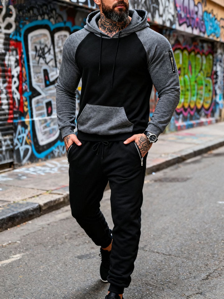 Men's two-piece hooded sweat set with raglan sleeves, sleeve zip pocket, and tapered jogging pants Mune Fashion