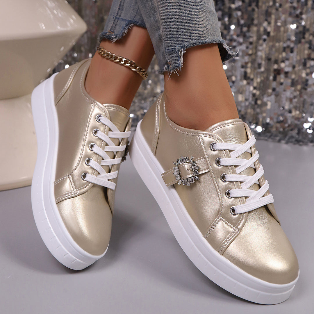 Ladies' platform sneaker with metallic upper material, decorative rhinestone buckle, and padded comfort sole Mune Fashion