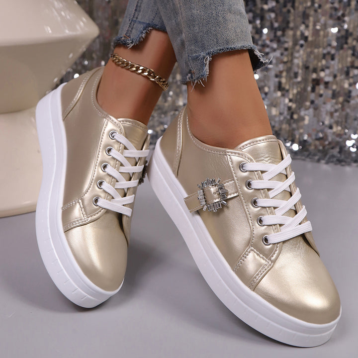 Ladies' platform sneaker with metallic upper material, decorative rhinestone buckle, and padded comfort sole Mune Fashion
