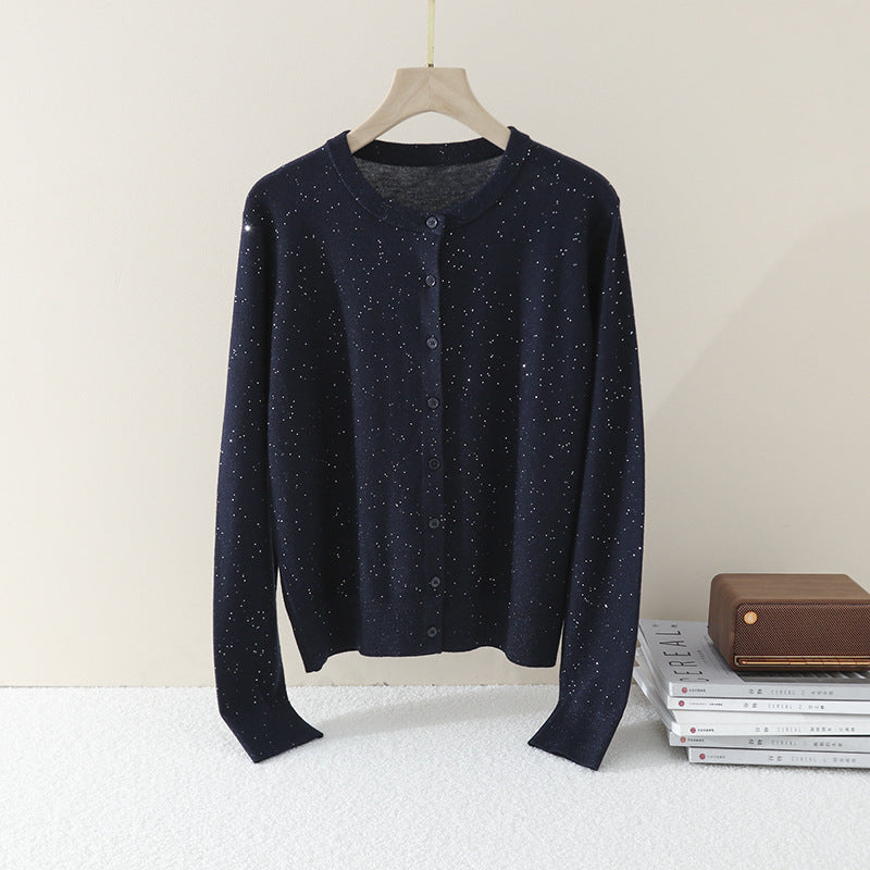 Women's fine round neck cardigan made of lightweight fine knit with pearl button placket and subtle glitter effect.