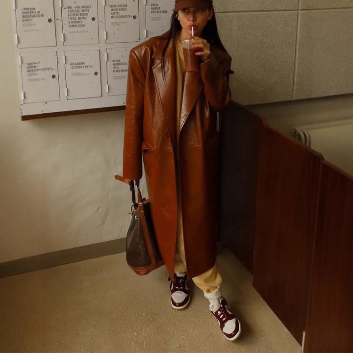 Women's long-cut patent leather trench coat with lapel collar and boxy oversized fit Mune Fashion