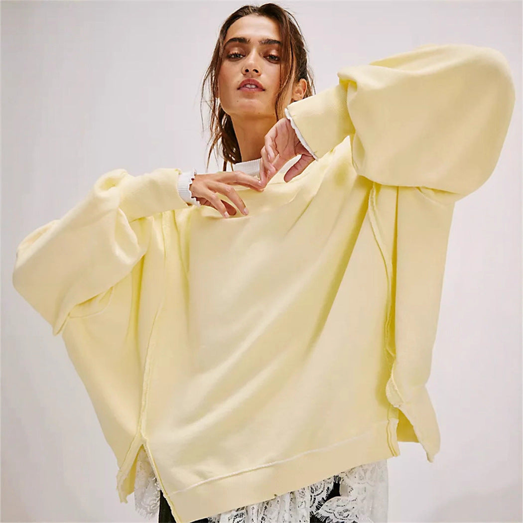 Women's oversized sweatshirt with balloon sleeves, open seam stitches, and side slits Mune Fashion