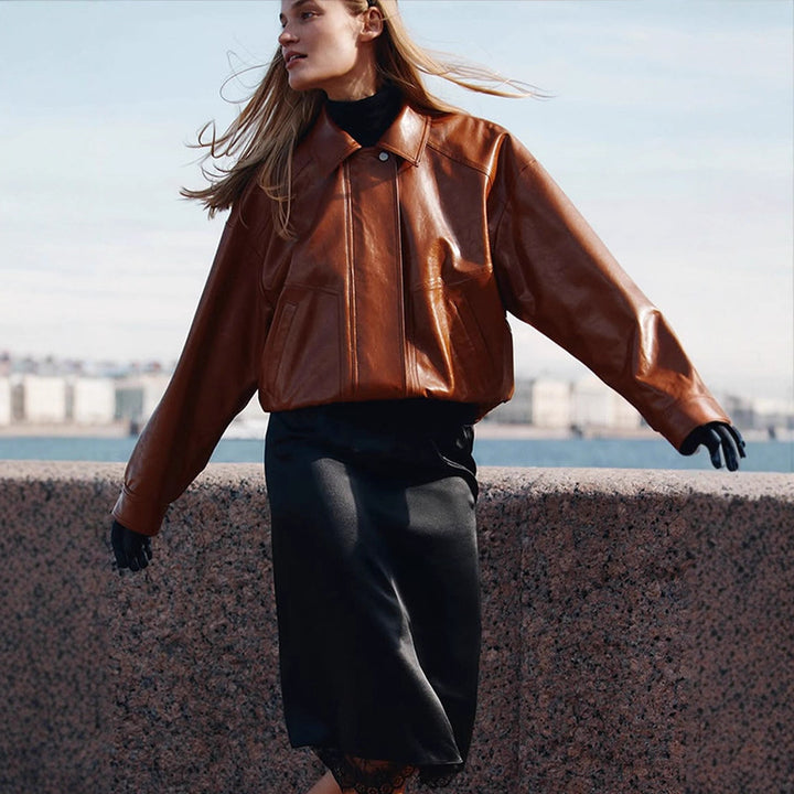 Women's short blazer made of vegan smooth leather with boxy silhouette and concealed snap button placket Mune Fashion