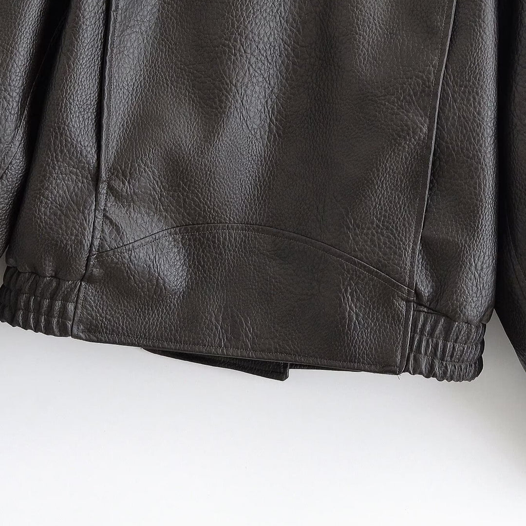 Women’s short jacket in aviator style made of synthetic leather with high standing collar, shoulder straps, and fitted ribbed hem Mune Fashion