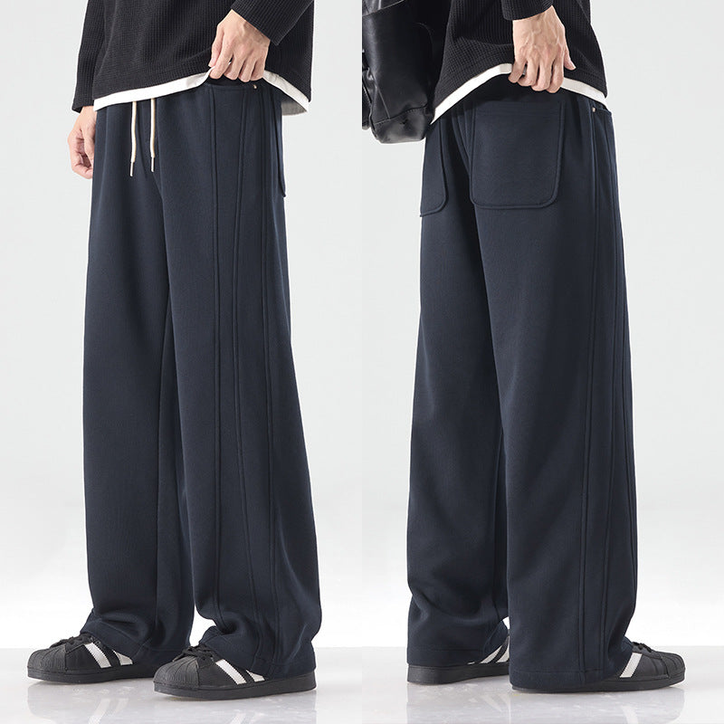 Men's loose sweatpants with decorative seam piping and drawstring