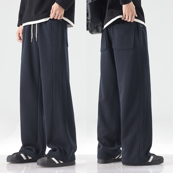 Men's loose sweatpants with decorative seam piping and drawstring