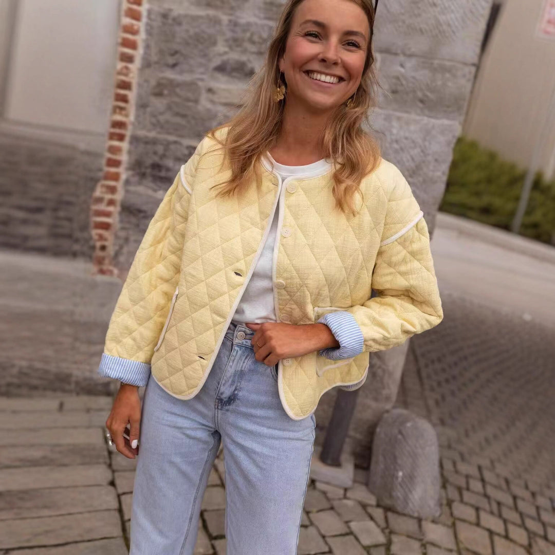 Women's quilted short jacket with diamond quilting, contrasting piping, and rounded hem Mune Fashion