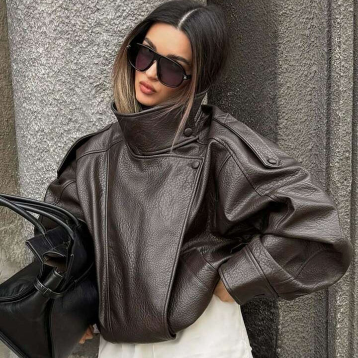 Ladies oversized biker jacket faux leather look with high stand-up collar, asymmetrical snap button front, shoulder straps and elastic hem Mune Fashion