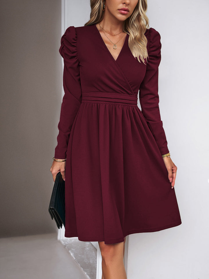 Women's wrap dress with V-neck, gathered puff sleeves, and fitted pleated skirt Drune