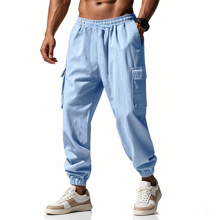 Men's tapered joggers in utilitarian style with elastic waistband, drawstring, and flap pockets Mune Fashion