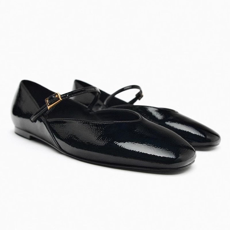 Women's elegant patent leather Mary Jane ballerina flats with a fine metal buckle and pointed toe cap.