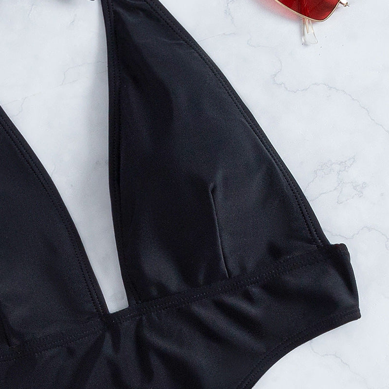 Women's one-piece swimsuit with deep V-neck and side cut-out.