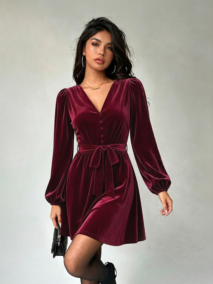 Women's elegant velvet mini dress with V-neck, button placket, balloon sleeves, and waist belt.
