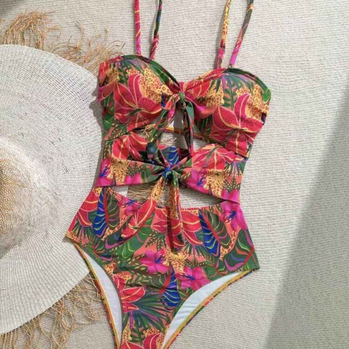 Women's one-piece swimsuit with decorative knot detail and playful floral design Mune Fashion