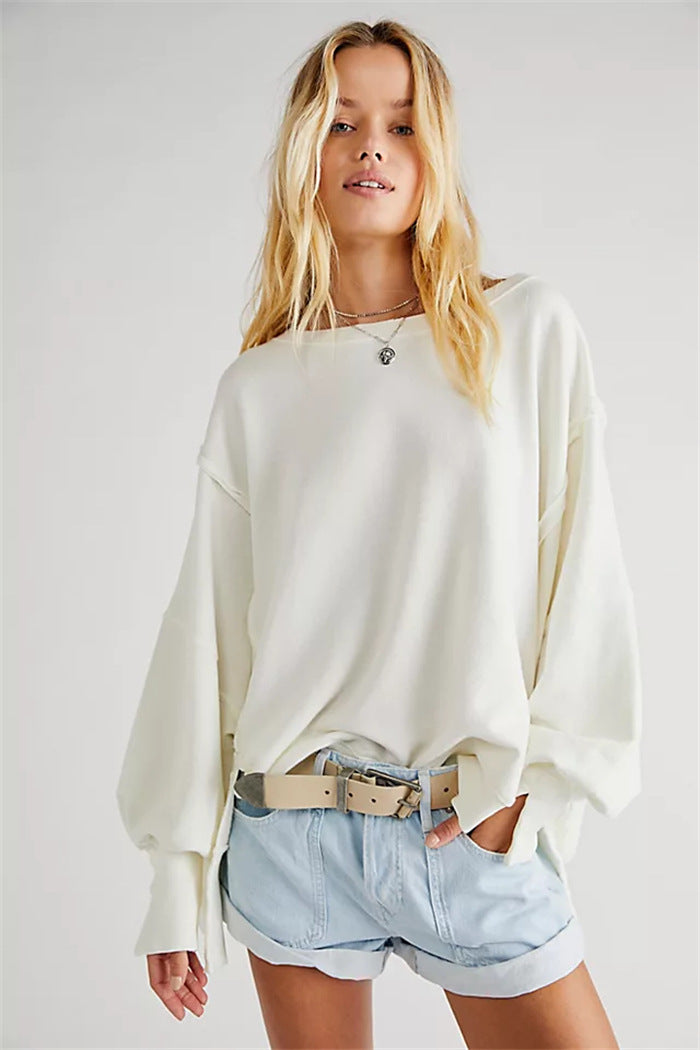 Women's oversized sweatshirt with balloon sleeves, open seam stitches, and side slits Mune Fashion