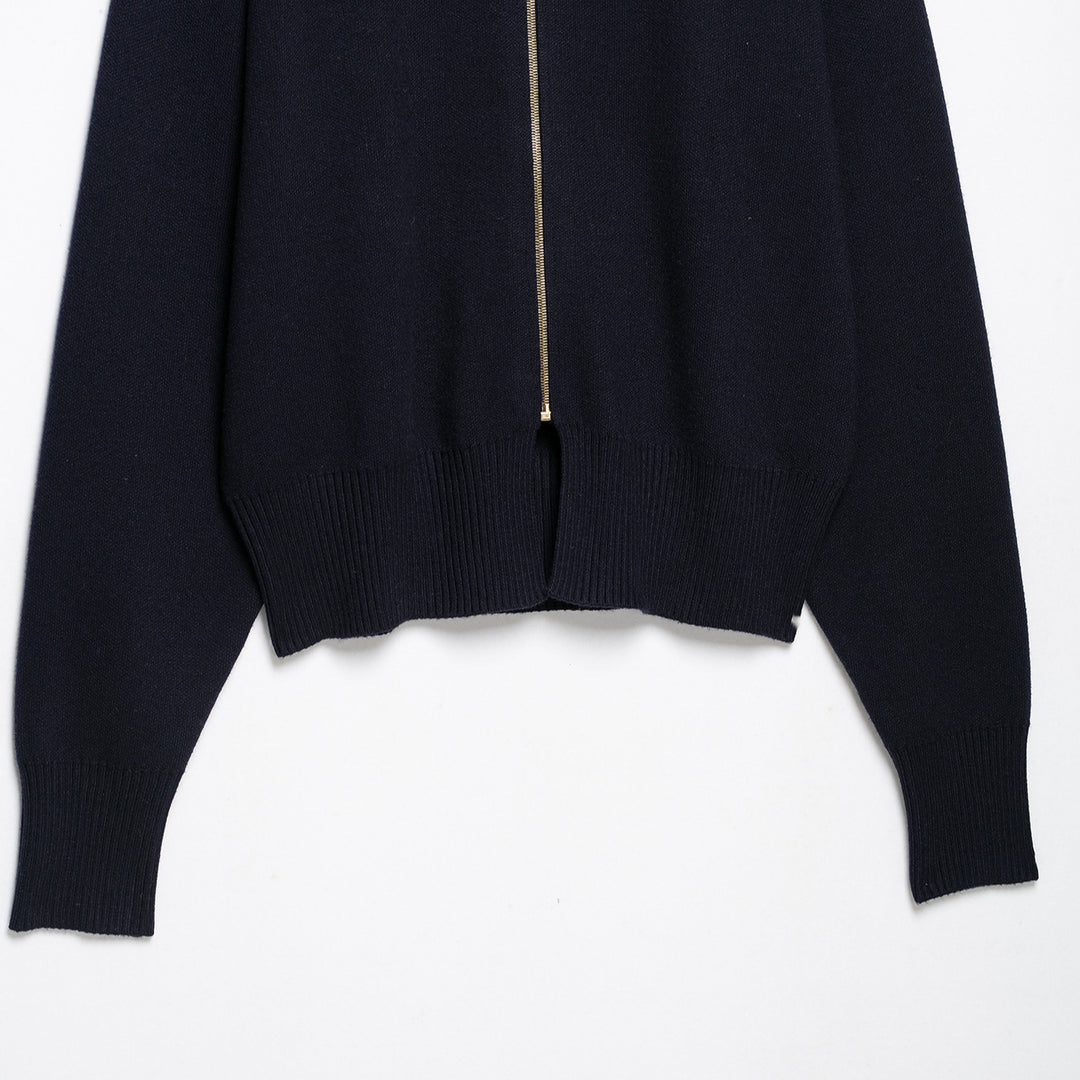 Women's cropped fine-knit cardigan with standing collar, full-length zipper, and fitted ribbed section.