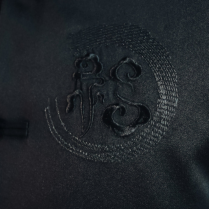 Men's Asian-inspired Mandarin jacket with stand-up collar, knot button placket, and tonal embroidered emblem Mune Fashion