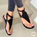 Women’s flat T-strap thong sandals with adjustable ankle strap and decorative floral appliqué in faux leather Mune Fashion