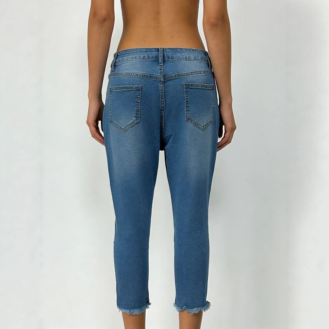 Women's narrow ankle-length jeans with raw fringe finish and mid-rise waist Mune Fashion
