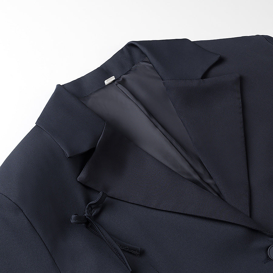 Women's tailored blazer with decorative bow appliqués and classic button placket Mune Fashion