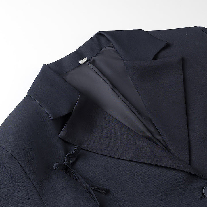 Women's tailored blazer with decorative bow appliqués and classic button placket Mune Fashion