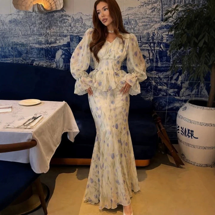 Women's dress made of transparent chiffon with fitted bodice, ruffled peplum and voluminous bell sleeves Mune Fashion