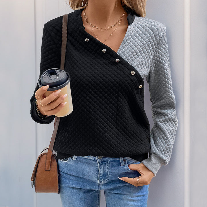 Women’s quilted sweatshirt with asymmetric lapel, decorative press buttons, and color block sleeves Mune Fashion
