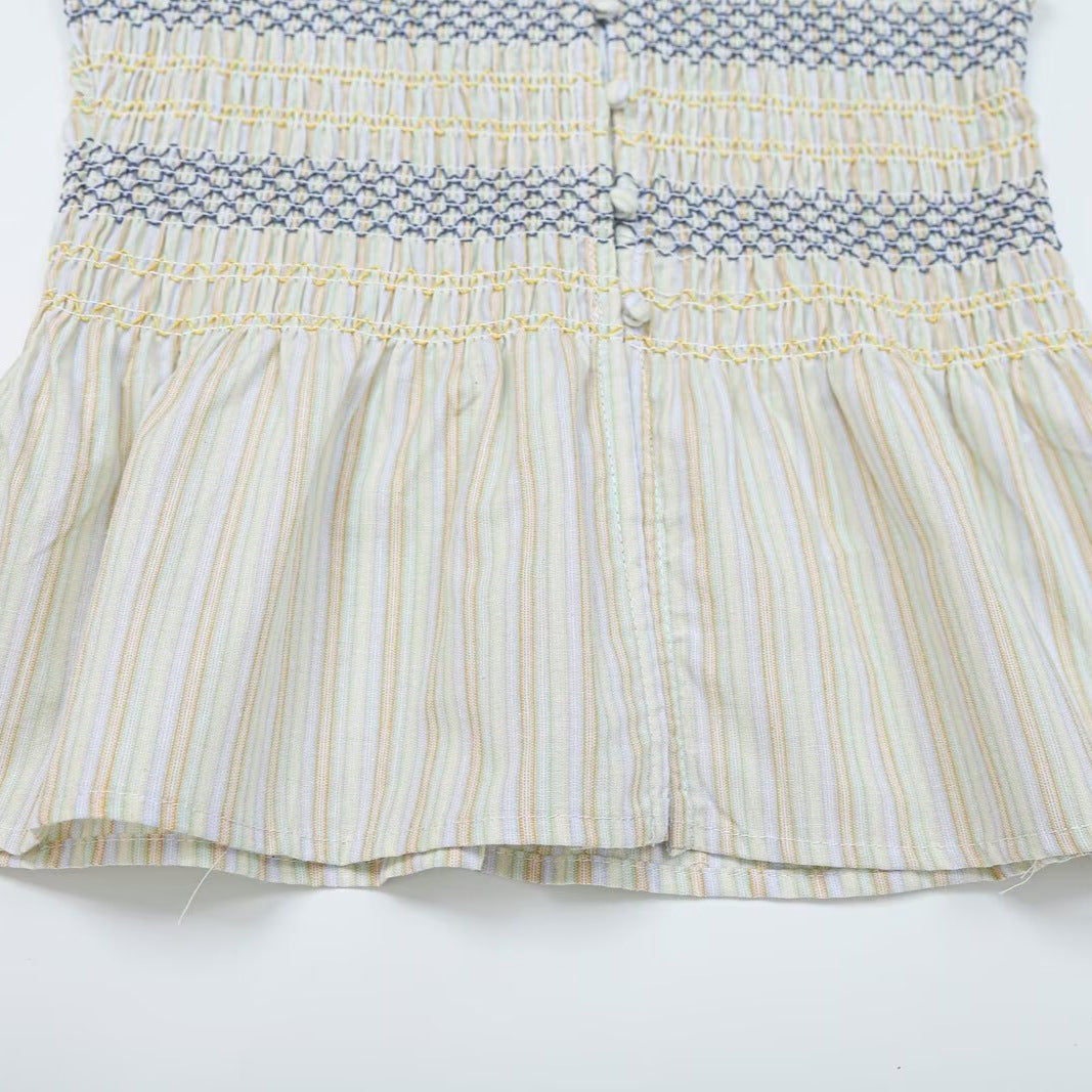 Women's gathered sleeveless top with smocked bodice, button placket, and flared hem Mune Fashion