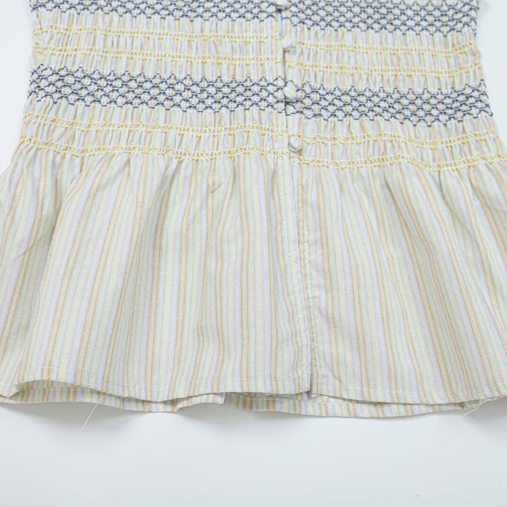 Women's gathered sleeveless top with smocked bodice, button placket, and flared hem Mune Fashion