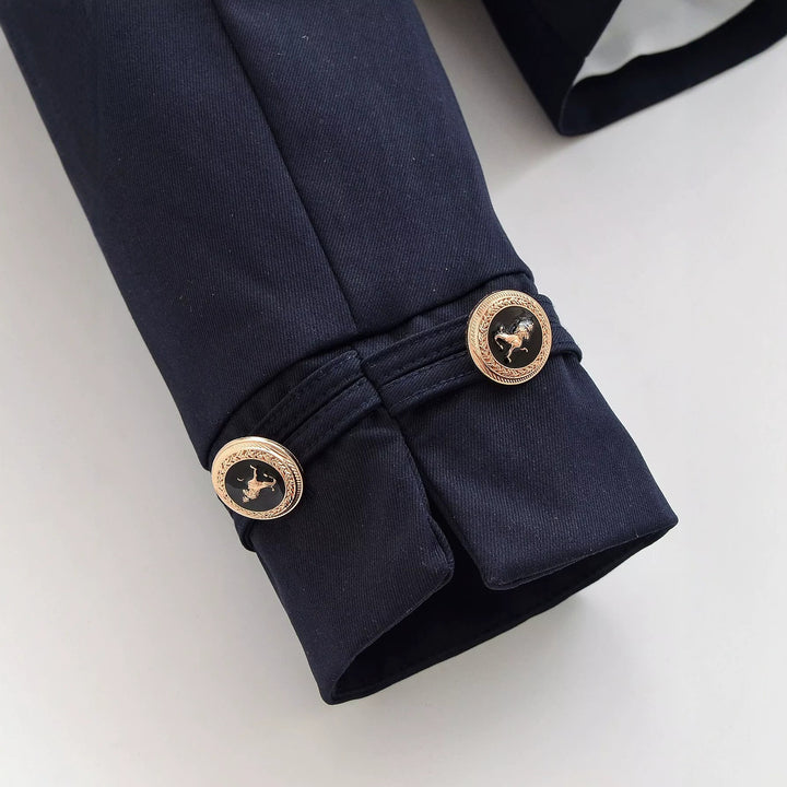 Women's short blazer with stand-up collar, gold-colored decorative buttons, and patch pockets Mune Fashion