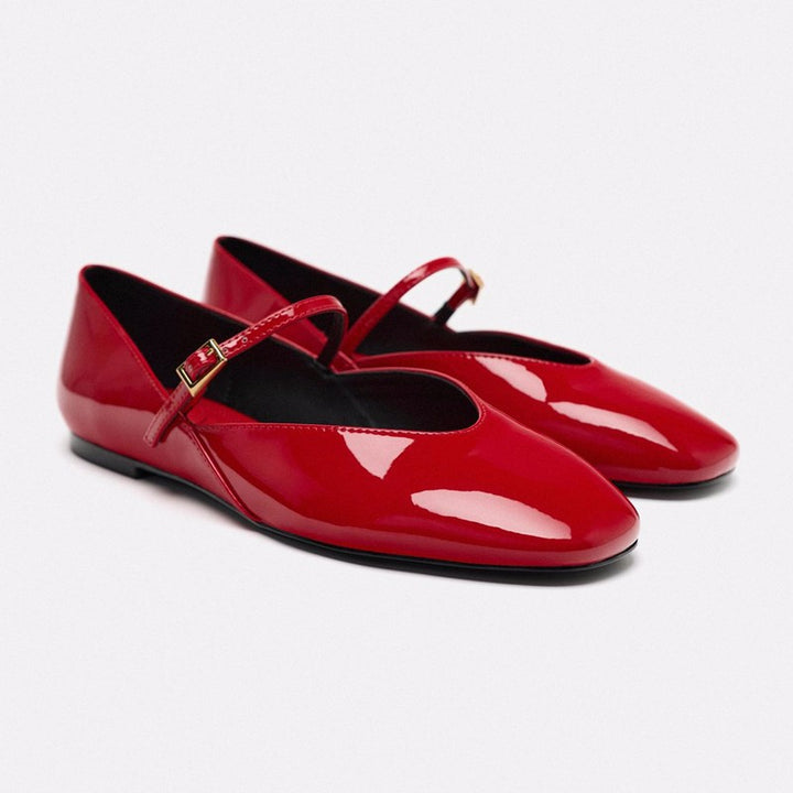 Women's elegant patent leather Mary Jane ballerina flats with a fine metal buckle and pointed toe cap.
