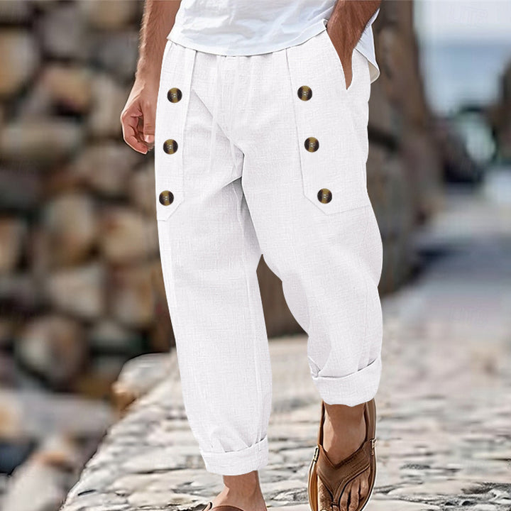 Men's loose linen trousers with decorative button stripes, rolled ankle cuffs, and side pockets Mune Fashion
