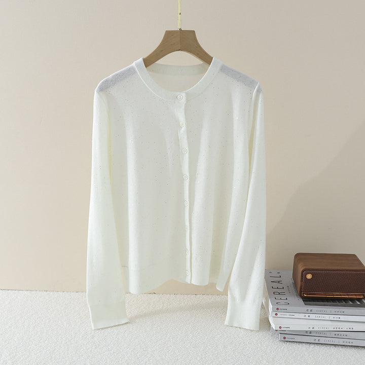 Women's fine round neck cardigan made of lightweight fine knit with pearl button placket and subtle glitter effect.