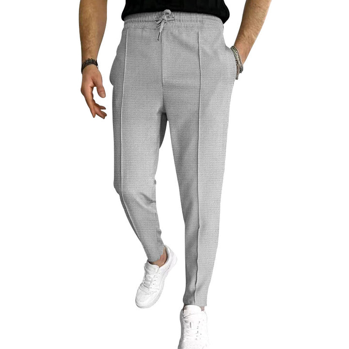 Men's tapered jogging chinos made of structured woven quality with elastic drawstring waistband and decorative crease Mune Fashion