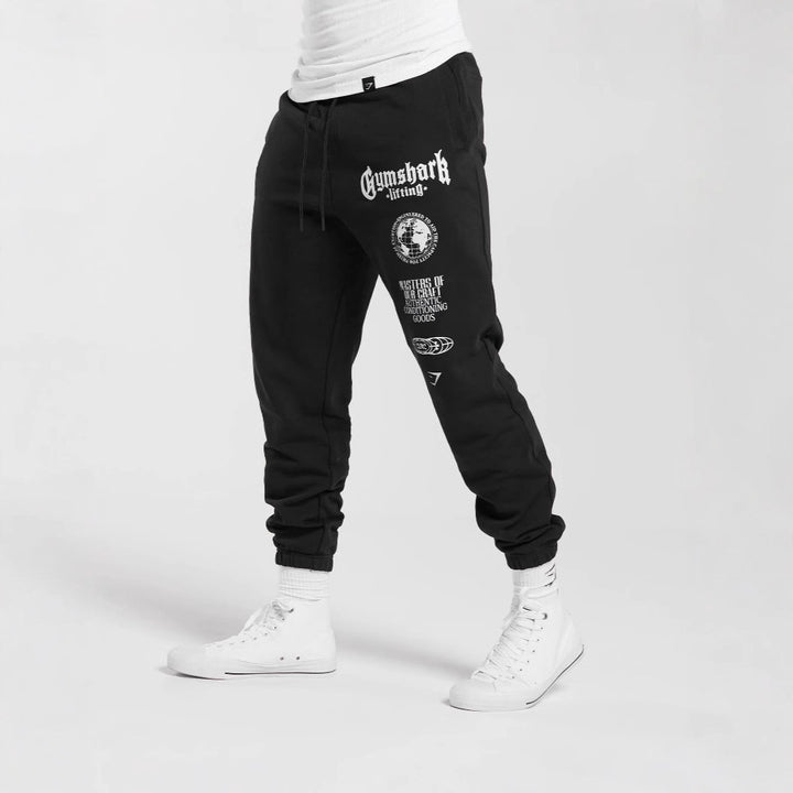 Men's tapered cotton fleece sweatpants with an elastic drawstring waistband, ribbed leg openings, and large logo print Mune Fashion